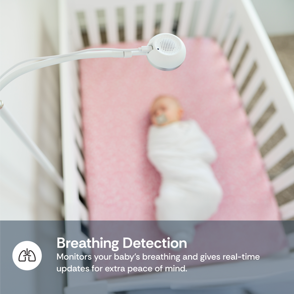 Baby monitor over a crib with a baby, featuring breathing detection technology.