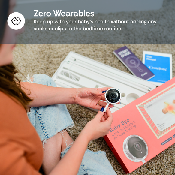 Person holding a baby monitor with 'Baby Eye' packaging on a carpeted floor.
