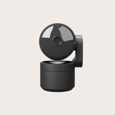 Black camera with rotating lens on a light gray background