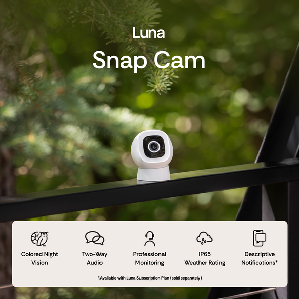 Luna Snap Cam on a railing with greenery in the background