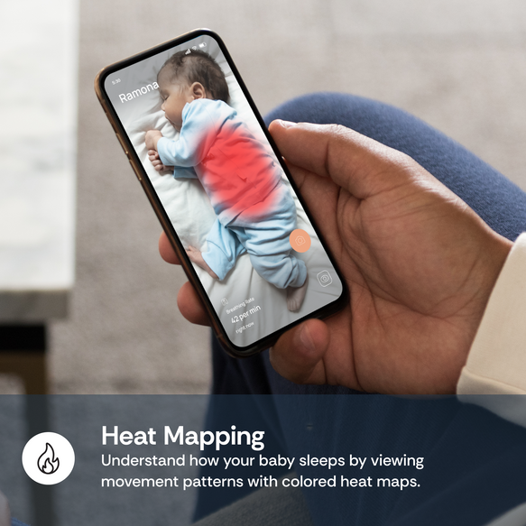Hand holding a smartphone with a heat mapping app showing a baby's sleep patterns.