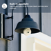 Wall-mounted spotlight lightbulb camera with text about its security benefits on a gray wall.