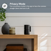Black camera on a wooden table with decorative items and privacy mode text overlay.