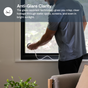 Person attaching a camera to an indoor window with text about anti-glare clarity technology.